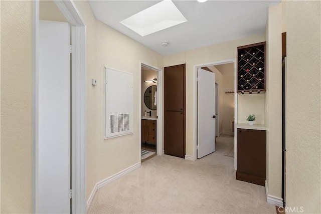 44 Corniche Dr Unit G, Dana Point, CA 92629 - hall featuring a skylight, light carpet, and baseboards