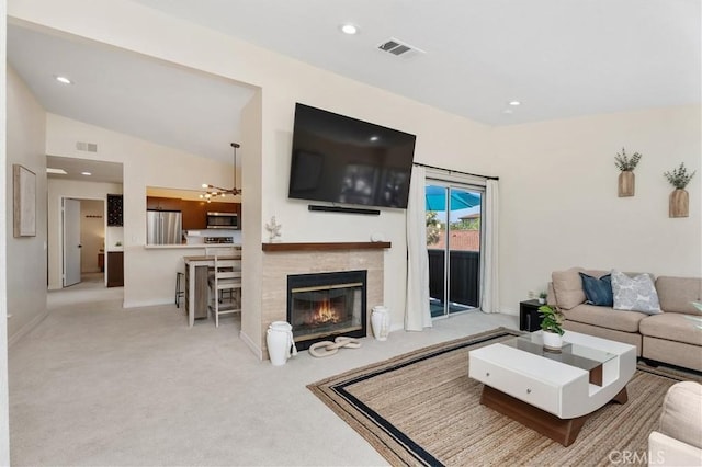 44 Corniche Dr Unit G, Dana Point, CA 92629 - carpeted living room with a chandelier, recessed lighting, vaulted ceiling, a tile fireplace, and baseboards