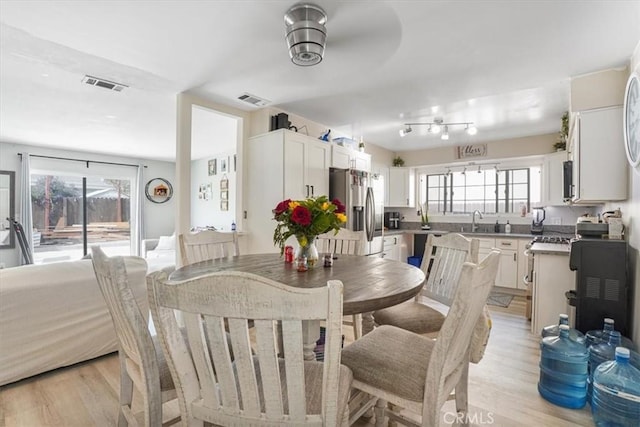 2111 Sanford St, Oxnard, CA 93033 - dining room with light wood finished floors and visible vents