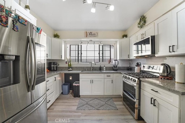 2111 Sanford St, Oxnard, CA 93033 - kitchen featuring a sink, white cabinetry, plenty of natural light, and appliances with stainless steel finishes