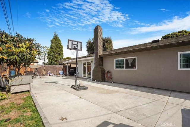 2111 Sanford St, Oxnard, CA 93033 - rear view of property featuring a patio area, fence, stucco siding, and a chimney