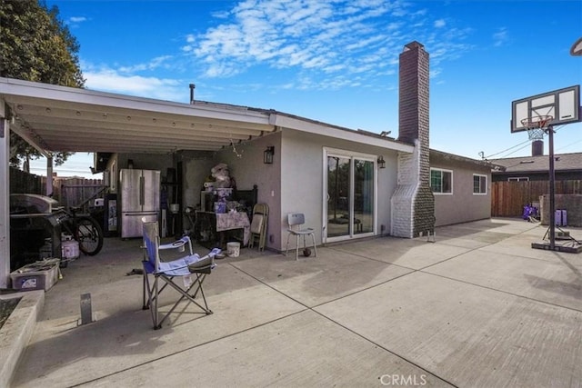 2111 Sanford St, Oxnard, CA 93033 - back of house featuring fence, stucco siding, and a chimney