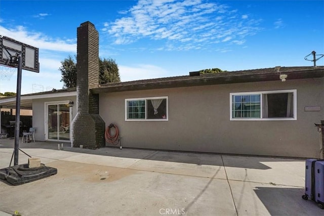 2111 Sanford St, Oxnard, CA 93033 - rear view of property featuring stucco siding, a chimney, and a patio