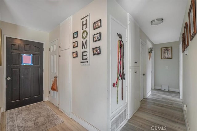 2111 Sanford St, Oxnard, CA 93033 - entrance foyer with baseboards, light wood finished floors, and visible vents
