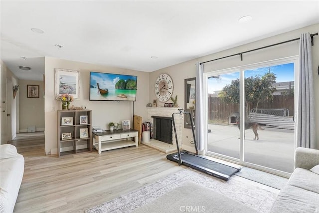 2111 Sanford St, Oxnard, CA 93033 - living room featuring wood finished floors, a fireplace with raised hearth, and recessed lighting