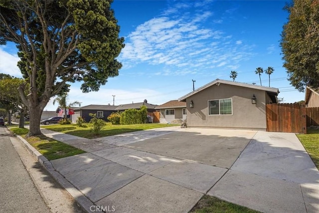 2111 Sanford St, Oxnard, CA 93033 - view of front of house with fence, stucco siding, a front lawn, and driveway