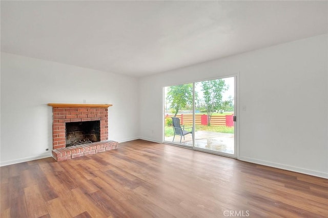 419 San Jacinto St, Redlands, CA 92373 - unfurnished living room with a fireplace, baseboards, and wood finished floors