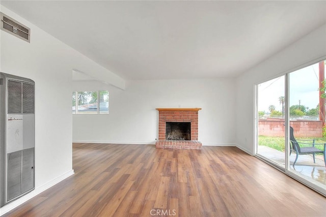 419 San Jacinto St, Redlands, CA 92373 - unfurnished living room with baseboards, a heating unit, visible vents, and wood finished floors