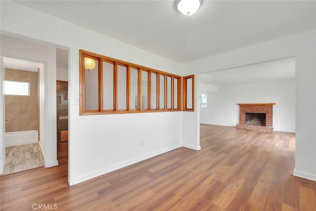 419 San Jacinto St, Redlands, CA 92373 - unfurnished living room featuring baseboards, a wealth of natural light, and wood finished floors