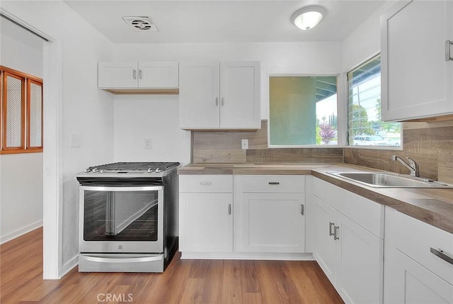 419 San Jacinto St, Redlands, CA 92373 - kitchen featuring white cabinetry, stainless steel range with gas stovetop, and a sink