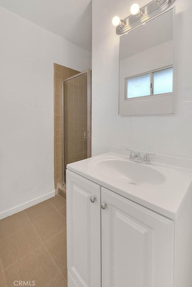 419 San Jacinto St, Redlands, CA 92373 - bathroom with a stall shower, vanity, baseboards, and tile patterned floors