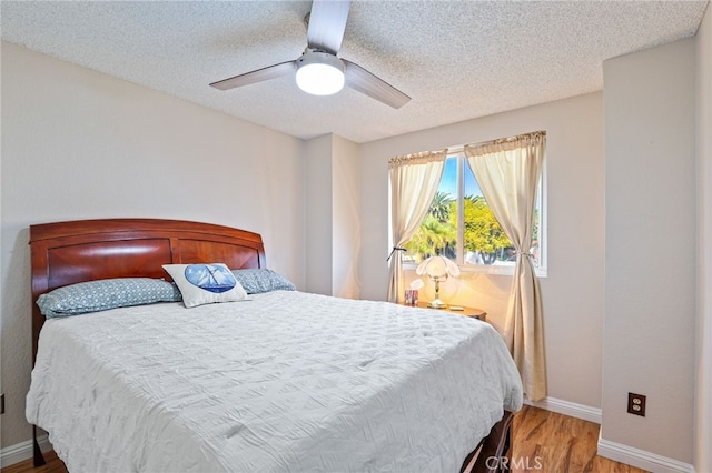 9387 Hot Springs Rd, Corona, CA 92883 - bedroom featuring baseboards, ceiling fan, a textured ceiling, and wood finished floors