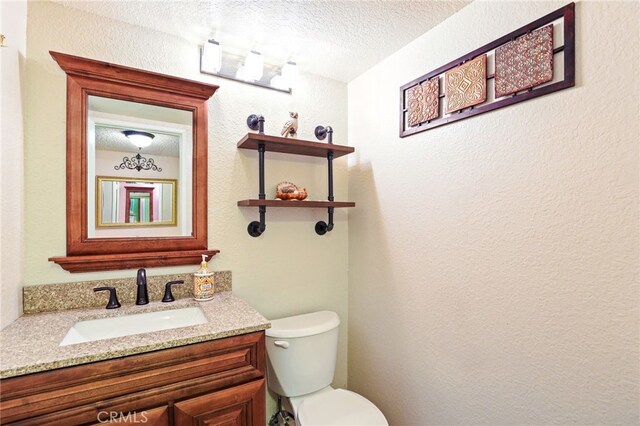 9387 Hot Springs Rd, Corona, CA 92883 - bathroom with toilet, vanity, a textured ceiling, and a textured wall