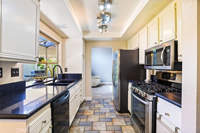 9387 Hot Springs Rd, Corona, CA 92883 - kitchen with a sink, stainless steel appliances, stone finish floor, white cabinets, and a raised ceiling