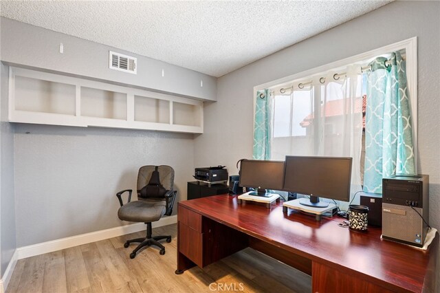 9387 Hot Springs Rd, Corona, CA 92883 - office featuring a textured ceiling, baseboards, visible vents, and light wood-style floors