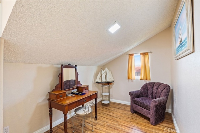 9387 Hot Springs Rd, Corona, CA 92883 - living area featuring a textured ceiling, baseboards, light wood-style flooring, and lofted ceiling