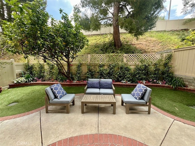 view of patio featuring an outdoor living space and a fenced backyard