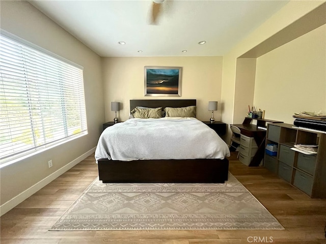 bedroom with baseboards, recessed lighting, and wood finished floors