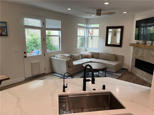1129 W Capitol Dr Unit 29, San Pedro, CA 90732 - living room with wood finished floors, a fireplace, baseboards, recessed lighting, and a ceiling fan