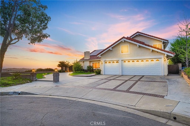 2302 Delfs Ln, Rowland Heights, CA 91748 - traditional home with driveway, roof mounted solar panels, stucco siding, a tile roof, and a chimney