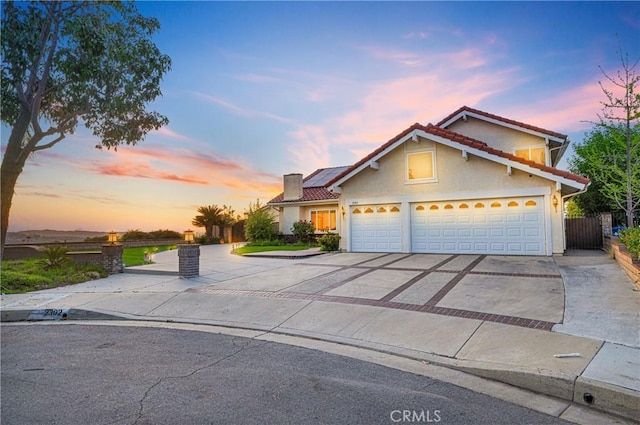 2302 Delfs Ln, Rowland Heights, CA 91748 - traditional-style house with driveway, roof mounted solar panels, stucco siding, a tile roof, and a chimney