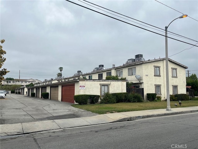 multi unit property with stucco siding and community garages