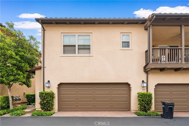 33 Jonquil, Irvine, CA 92618 - view of front of home with a balcony, stucco siding, a garage, and decorative driveway