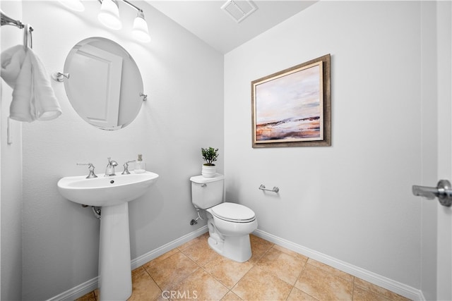 33 Jonquil, Irvine, CA 92618 - half bath featuring a sink, toilet, baseboards, and visible vents