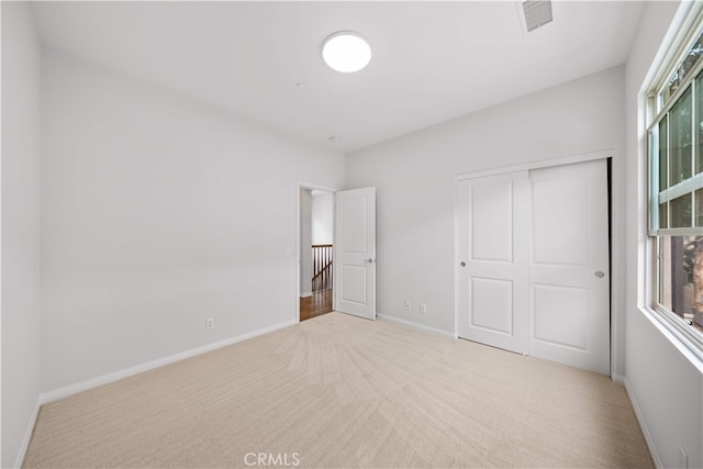33 Jonquil, Irvine, CA 92618 - unfurnished bedroom featuring baseboards, a closet, visible vents, and carpet