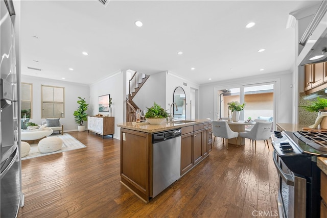 33 Jonquil, Irvine, CA 92618 - kitchen with stainless steel appliances, dark wood-style floors, a sink, ornamental molding, and light stone counters