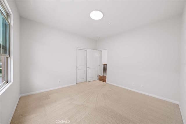 33 Jonquil, Irvine, CA 92618 - unfurnished bedroom featuring light carpet, baseboards, and a closet