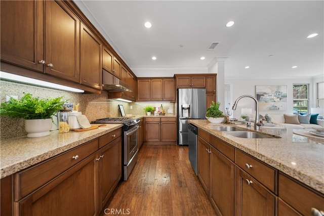 33 Jonquil, Irvine, CA 92618 - kitchen featuring a sink, stainless steel appliances, under cabinet range hood, light stone counters, and ornamental molding
