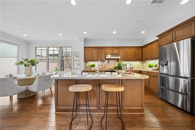 33 Jonquil, Irvine, CA 92618 - kitchen with brown cabinets, stainless steel fridge with ice dispenser, and crown molding