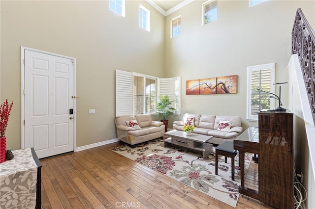 16673 Carob Ave, Chino Hills, CA 91709 - living area featuring a high ceiling, crown molding, wood-type flooring, healthy amount of natural light, and baseboards