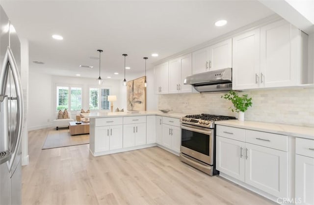 kitchen featuring under cabinet range hood, white cabinetry, a peninsula, light countertops, and appliances with stainless steel finishes