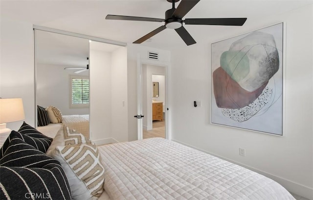 bedroom featuring baseboards, a ceiling fan, and visible vents