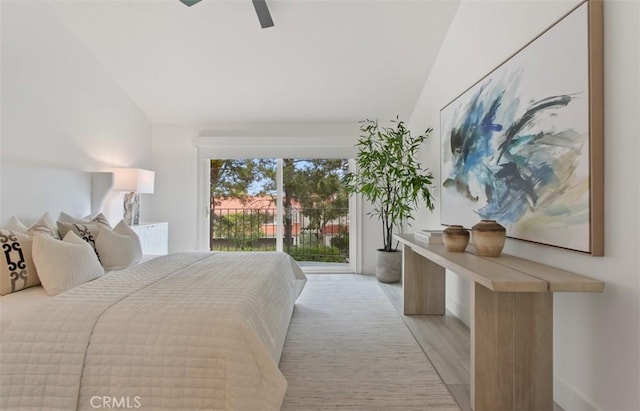 bedroom featuring lofted ceiling, light wood finished floors, access to outside, and ceiling fan