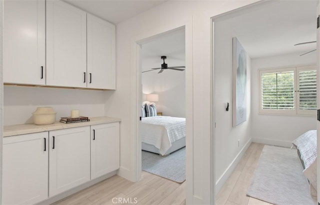 bedroom with light wood-style flooring and baseboards