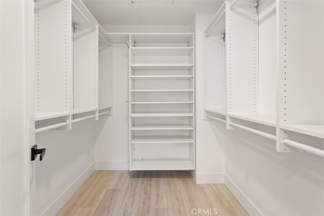 walk in closet featuring wood finished floors
