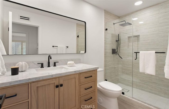 full bathroom with recessed lighting, toilet, visible vents, a shower stall, and vanity