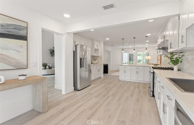 kitchen featuring range hood, visible vents, white cabinetry, a peninsula, and stainless steel appliances