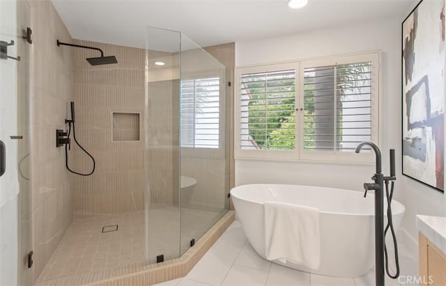 bathroom featuring recessed lighting, a shower stall, tile patterned flooring, a soaking tub, and vanity