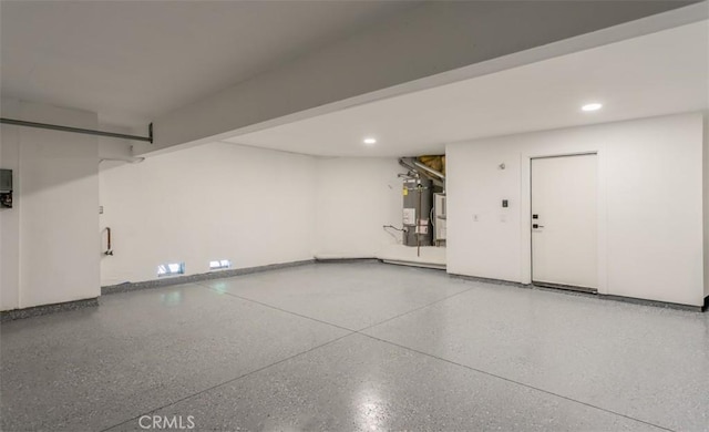 garage featuring gas water heater and recessed lighting