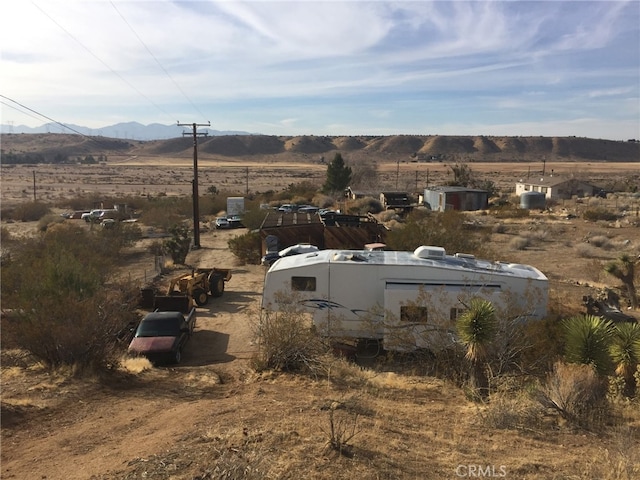 view of storm shelter featuring a rural view and a mountain view