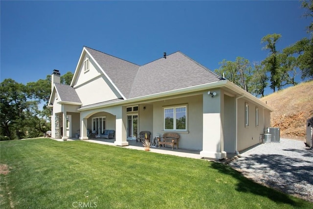 2483 Manhattan Bar Rd, Auburn, CA 95603 - rear view of property featuring a chimney, a shingled roof, a yard, stucco siding, and central AC unit