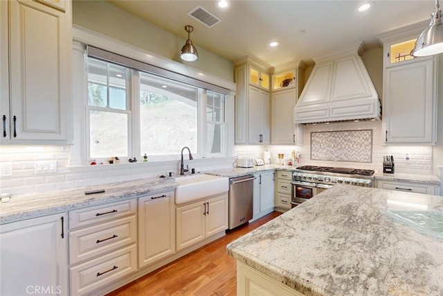2483 Manhattan Bar Rd, Auburn, CA 95603 - kitchen with custom exhaust hood, appliances with stainless steel finishes, a sink, light stone countertops, and recessed lighting
