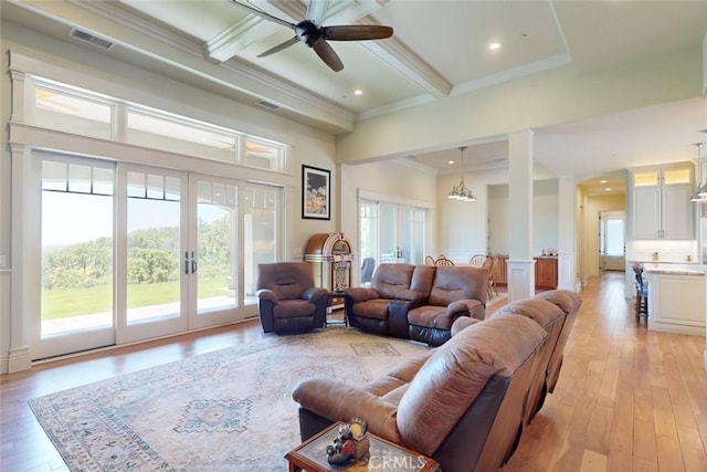 2483 Manhattan Bar Rd, Auburn, CA 95603 - living area featuring healthy amount of natural light, crown molding, beamed ceiling, light wood finished floors, and a ceiling fan