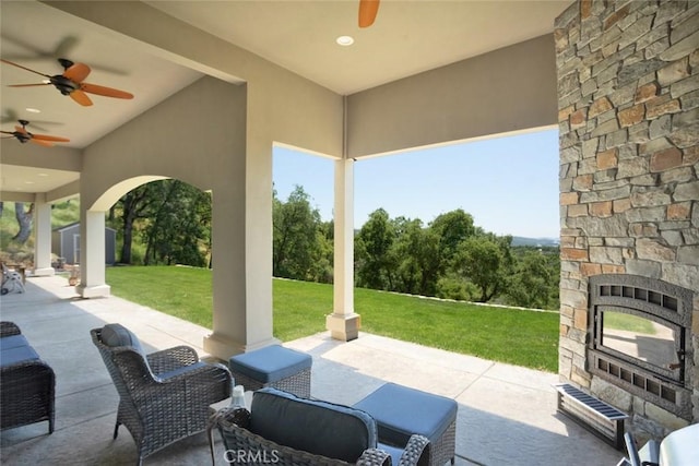 2483 Manhattan Bar Rd, Auburn, CA 95603 - view of patio / terrace with an outdoor stone fireplace and a ceiling fan