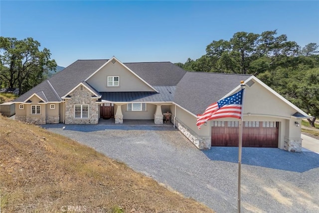 2483 Manhattan Bar Rd, Auburn, CA 95603 - view of front of property featuring stone siding, driveway, a garage, stucco siding, and a standing seam roof