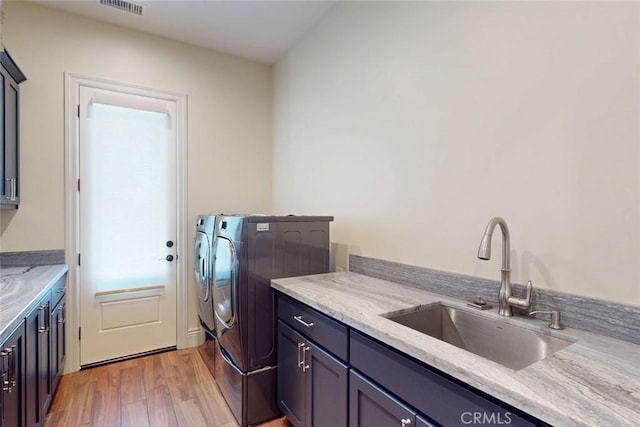 2483 Manhattan Bar Rd, Auburn, CA 95603 - laundry area featuring cabinet space, light wood finished floors, and washer and clothes dryer